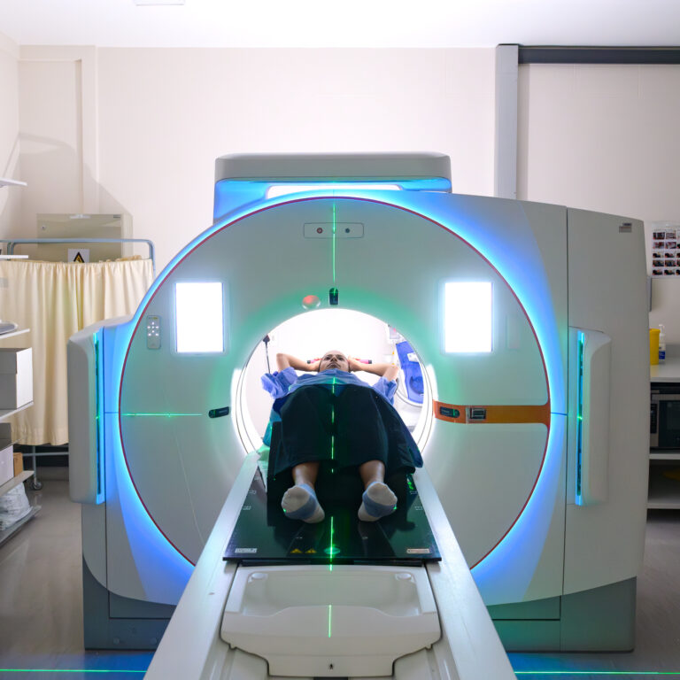 Medical professional administering a high-tech scan with a CT scanner simulator in a modern clinical hospital setting. The image captures a patient undergoing advanced diagnostic imaging, with equipment designed for precision. It conveys themes of healthcare, technology, and patient care.