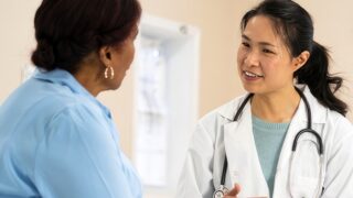 Physician confers with patient