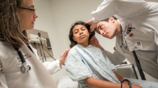 Family Medicine physician exams a patient