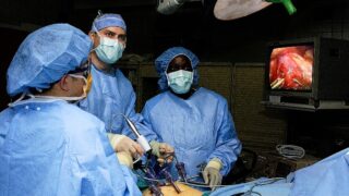 Surgeons perform laparoscopic stomach surgery.