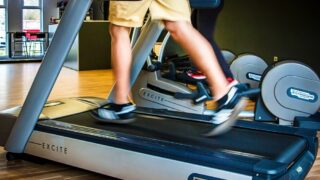 Man's legs shown running on a treadmill