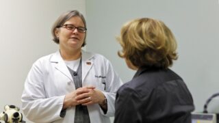 Physician speaks with patient