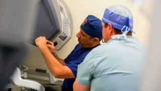 Dr. Gill speaking with with another physicianl