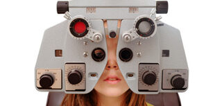 Girl looking through an ophthalmology examination device